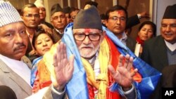 Nepal's newly elected Prime Minister Sushil Koirala waves to the media at the Constitution Assembly Hall in Katmandu, Nepal, Feb. 10, 2014.