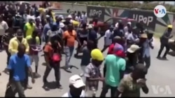 Sipòtè ansyen prezidan Jean Bertrand Aristide yo akeyi l apre li sot pran swen nan Kiba