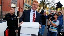 FILE - Former Penn State University assistant football coach Mike McQueary, center, leaves the Centre County Courthouse Annex in Bellefonte, Pa., Oct. 17, 2016. McQueary was awarded $7.3 million in his defamation and whistleblower lawsuit against Penn State over how it treated him for exposing child abuse at Penn State.