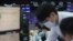FILE - Currency traders watch monitors at the foreign exchange dealing room of the KEB Hana Bank headquarters in Seoul, South Korea, Nov. 4, 2020. 