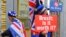 FILE - Anti-Brexit protesters stand outside the International Convention Center in Birmingham during a Conservative Party Conference at the ICC, in Birmingham, England, Oct. 2, 2018.