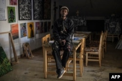 FILE—Founder and Artistic Director for “Art for Memories,” King Ngabo, 28, poses for a portrait in his studio in Kigali on April 2, 2024.