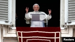 Pope Benedict waves as he leads his last Sunday prayers at the Vatican on February 24, 2013.