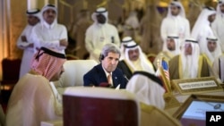 U.S. Secretary of State John Kerry, center, listens during a foreign ministers meeting of the Gulf Cooperation Council, in Doha, Qatar, Monday, Aug. 3, 2015. 