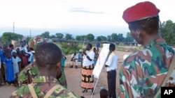 An aid worker talks to soldiers and scouts in Juba in October 2005, about how to spread the message on HIV/AIDS. HIV infections are down in South Sudan, a government report says. file photo)