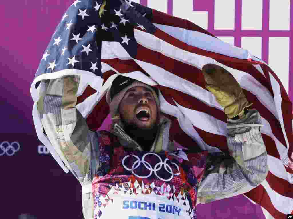 United States' Sage Kotsenburg celebrates after winning the men's snowboard slopestyle final at the Rosa Khutor Extreme Park, at the 2014 Winter Olympics, in Krasnaya Polyana, Russia.