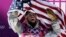 United States' Sage Kotsenburg celebrates after winning the men's snowboard slopestyle final at the Rosa Khutor Extreme Park, at the 2014 Winter Olympics, in Krasnaya Polyana, Russia, Feb. 8, 2014. 