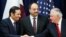 Qatar's Foreign Minister Sheikh Mohammed bin Abdulrahman Al Thani, left, next to Qatar's Defense Minister Khalid bin Mohammad al-Attiyah, shakes hands with Secretary of State Rex Tillerson, right, ‎at the State Department in Washington, Jan. 30, 2018.
