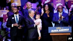 Democratic presidential candidate and former New York City Mayor Michael Bloomberg is joined on stage by supporters during his campaign launch of "Mike for Black America," at the Buffalo Soldiers National Museum, Feb. 13, 2020, in Houston.