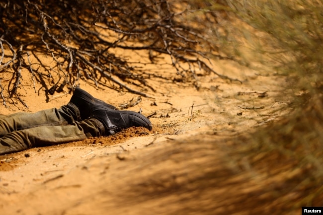 The body of a dead migrant lies in a desert area outside Sunland Park, New Mexico, on Aug. 17, 2023.