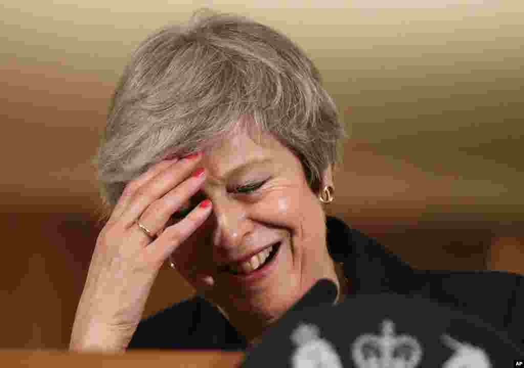 Britain's Prime Minister Theresa May reacts during a press conference inside 10 Downing Street in London. Two cabinet ministers, including Brexit Secretary Dominic Raab, resigned in opposition to the divorce deal struck by Prime Minister Theresa May with the EU — a major blow to her authority and her ability to get the deal through Parliament.