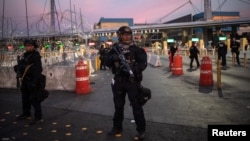 FILE - U.S. Customs and Border Protection Special Response Team officers stand guard at the San Ysidro Port of Entry after the land border crossing was temporarily closed to traffic from Tijuana, Mexico, Nov. 19, 2018.