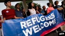 FILE - Activists hold a banner during a demonstration organized by HIAS, founded as the Hebrew Immigrant Aid Society, outside the U.S. Capitol in Washington, Sept. 14, 2017. HIAS, the Jewish nonprofit singled out by the Pittsburgh synagogue assailant, is one of a number of religious-affiliated groups in the United States that provide help to refugees.