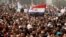 FILE - A man holds an Egyptian flag during a rally at Tahrir Square, in Cairo, Feb. 25, 2011. 