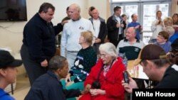 President Barack Obama and New Jersey Gov. Chris Christie talk with local residents at the Brigantine Beach Community Center in Brigantine, New Jersey, October 31, 2012. 