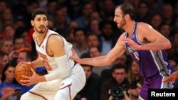 FILE - New York Knicks center Enes Kanter, left, controls the ball against Sacramento Kings center Kosta Koufos at Madison Square Garden in New York, Nov. 11, 2017.