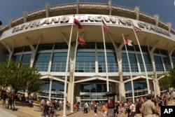 FILE - Fans walk into Cleveland Browns Stadium, Sept. 13, 2009, in Cleveland. A U.S. company boasted of the "stunning visual effect" its shimmering aluminum panels created in on the NFL stadium, an Alaskan school and a 33-story hotel on Baltimore's waterfront hotel.