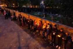 People line up for a human chain around the Jewish synagogue and the cemetery during the Sabbath celebrations in Halle, Germany, Oct. 11, 2019.