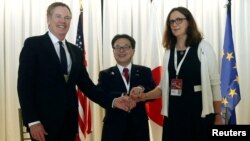 U.S. Trade Representative Robert Lighthizer, Japanese Minister of Economy,Trade and Industry Hiroshige Seko and European Commissioner for Trade Cecilia Malmstrom pose for a photo during a meeting at the 11th World Trade Organization's ministerial conferen