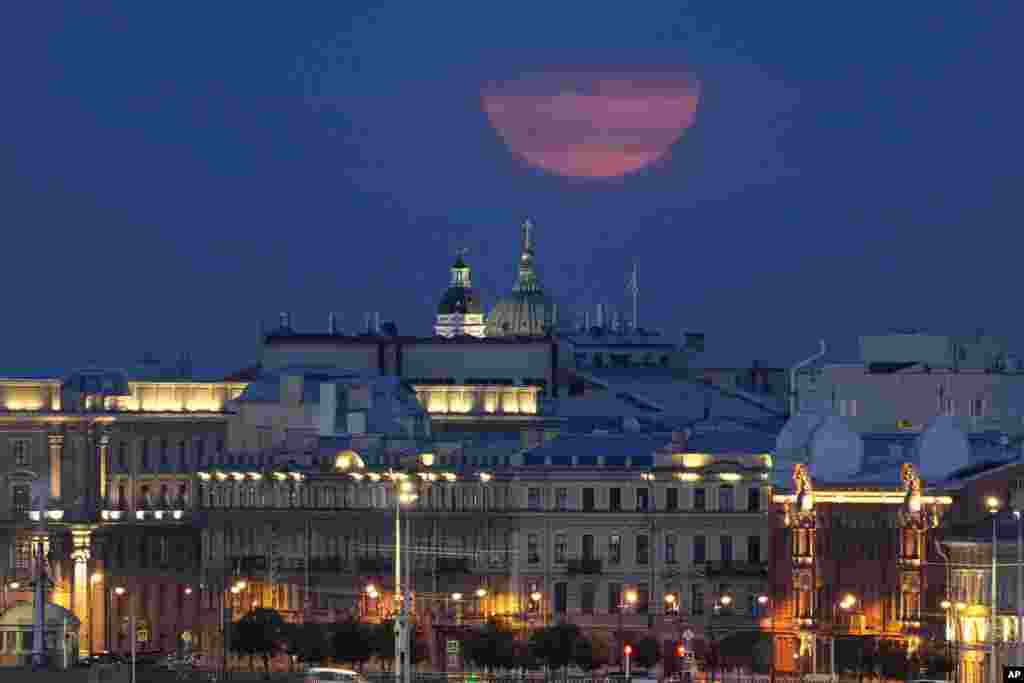 The super moon rises in the clouds over St. Petersburg, Russia, Aug. 19, 2024.