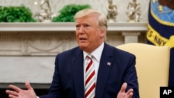 FILE - President Donald Trump speaks to reporters in the Oval Office of the White House.