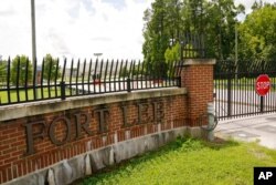 FILE - A sign marks an entrance to U.S. Army base Fort Lee, Aug. 17, 2021, in Petersburg, Va. Afghan refugees who have been prescreened by the U.S. Department of Homeland Security have been taken to Fort Lee and other temporary reception centers.