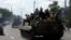Pro-Russian separatist fighters on armored vehicles in the eastern Ukrainian city of Donetsk, July 10, 2014.