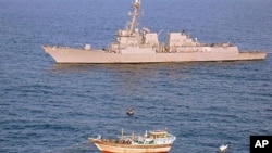 The guided-missile destroyer USS Kidd responds to a distress call from the Iranian-flagged fishing vessel Al Molai, which was being held captive by pirates in the Arabian Sea, January 5, 2012.