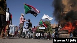 Sudan protesters - burnt tires tyres burned - smoke - fire - barricade Khartoum