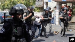 Israeli border police officers detain a Palestinian during clashes in Jerusalem, July 21, 2017.