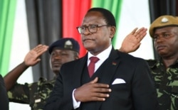 FILE - Malawi's newly elected President Lazarus Chakwera takes the oath of office in Lilongwe, Malawi, June 28, 2020.