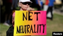 FILE - Lori Erlendsson attends a pro-net neutrality Internet activist rally in the neighborhood where President Barack Obama attended a fundraiser in Los Angeles, California 