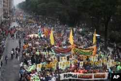 FILE - More than 100,000 people march through Manhattan, Sept. 21, 2014, as part of the People's Climate March, a mobilization calling on world leaders to commit to urgent action on climate change and 100 percent clean energy in New York.