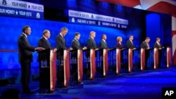 Republican presidential candidates, from left, John Kasich, Mike Huckabee, Jeb Bush, Marco Rubio, Donald Trump, Ben Carson, Carly Fiorina, Ted Cruz, Chris Christie and Rand Paul take the stage during the CNBC Republican presidential debate at the University of Colorado, Oct. 28, 2015.