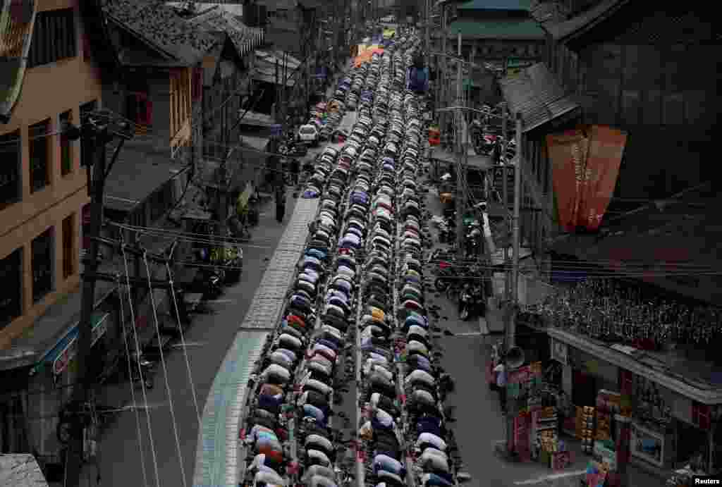 People offer annual congregational prayers called "Khoja Digar" on the 3rd of Rabi-ul-Awwal, the third month of the Islamic calendar, outside the shrine of Sufi Saint Khawaja Naqashband on his death anniversary, in Srinagar, India.