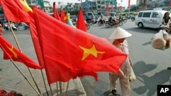 FILE - Vietnamese flag sales to mark the 30th anniversary of the end of the war in Ho Chi Minh city, formerly Saigon.