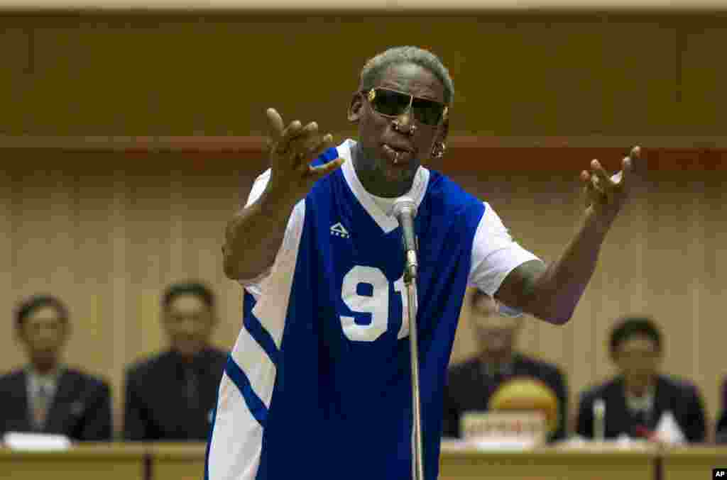 Dennis Rodman sings Happy Birthday to North Korean leader Kim Jong Un, seated above in the stands, before an exhibition basketball game in Pyongyang, Jan. 8, 2014. 