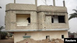 FILE - A broken and deserted house, which has a tunnel running underground, is seen in the Egyptian border city of Rafah, May 13, 2013. Egypt's says on Monday it found and destroyed 20 new tunnels last November.