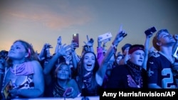 FILE - Festival-goers attend the Voodoo Music Experience in City Park in New Orleans, Oct. 27, 2019. Major concert promoters in the U.S. are stepping back from plans to scan festival-goers with facial recognition technology, at least for the time being.