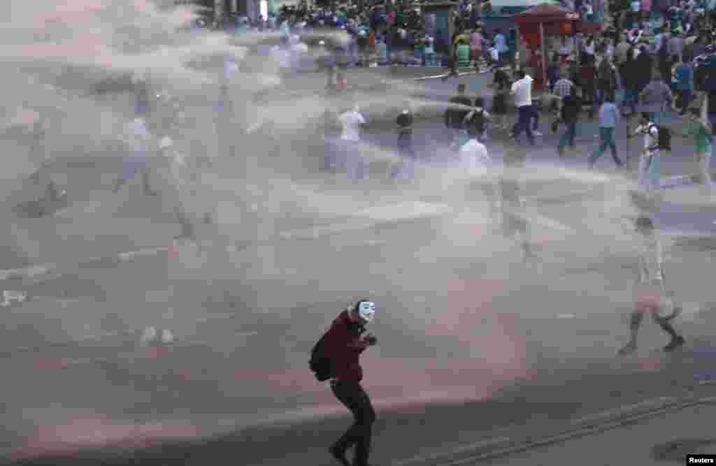 Riot police use a water cannon to disperse anti-government protesters at Taksim Square in central Istanbul, June 15, 2013.