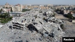 FILE—Residential buildings, destroyed in Israeli strikes during the conflict, lie in ruin, amid a temporary truce between Israel and the Palestinian Islamist group Hamas, in southern Gaza City November 26, 2023.