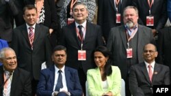 Raj Kumar Singh (bottom centre L), India's Minister of Power, New and Renewable Energy and president of the International Solar Alliance during a photo session with delegates at the sixth session of the International Solar Alliance assembly in New Delhi on October 31, 2023.