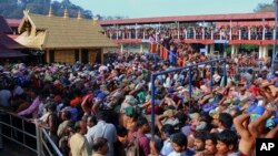 FILE - Hindu worshippers stand in long queues outside the Sabarimala temple in the southern Indian state of Kerala, Dec. 1, 2015.