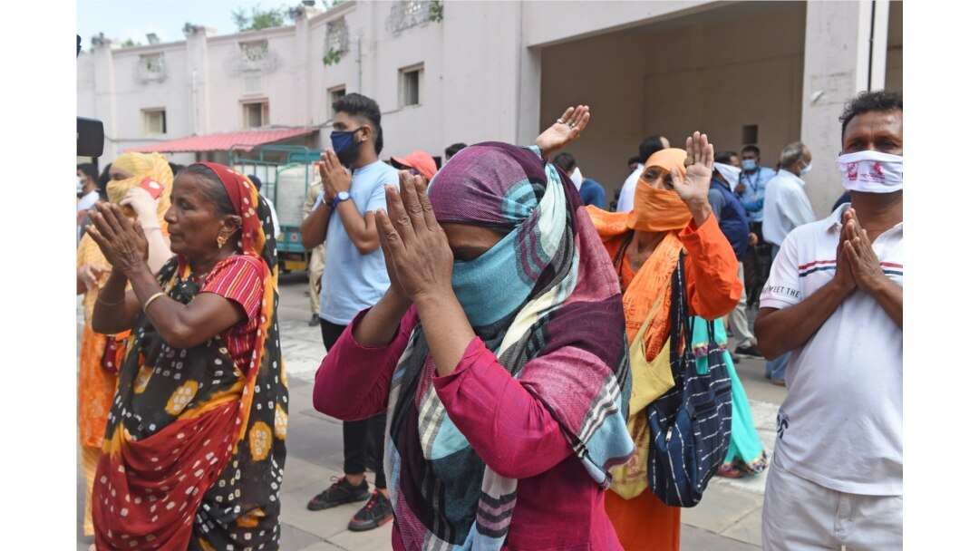 Hindu devotees offer prayers in front of a chariot carrying an idol of Lord Jagannath (not pictured) as the annual Rath Yatra procession was cancelled amid concerns over the spread of the COVID-19 coronavirus, in Ahmedabad, June 23, 2020.