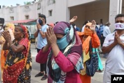 Hindu devotees offer prayers in front of a chariot carrying an idol of Lord Jagannath (not pictured) as the annual Rath Yatra procession was cancelled amid concerns over the spread of the COVID-19 coronavirus, in Ahmedabad, June 23, 2020.