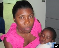 Clothilde Derosier, 25, with son Snyder, 3, after the teleconference at Notre Dame d'Haiti Catholic church in Little Haiti, 7 Apr 2010