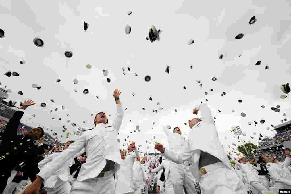 Graduates toss their hats after receiving their diplomas at the graduation and commissioning ceremony for the U.S. Naval Academy's Class of 2021, at the U.S. Naval Academy in Annapolis, Maryland.