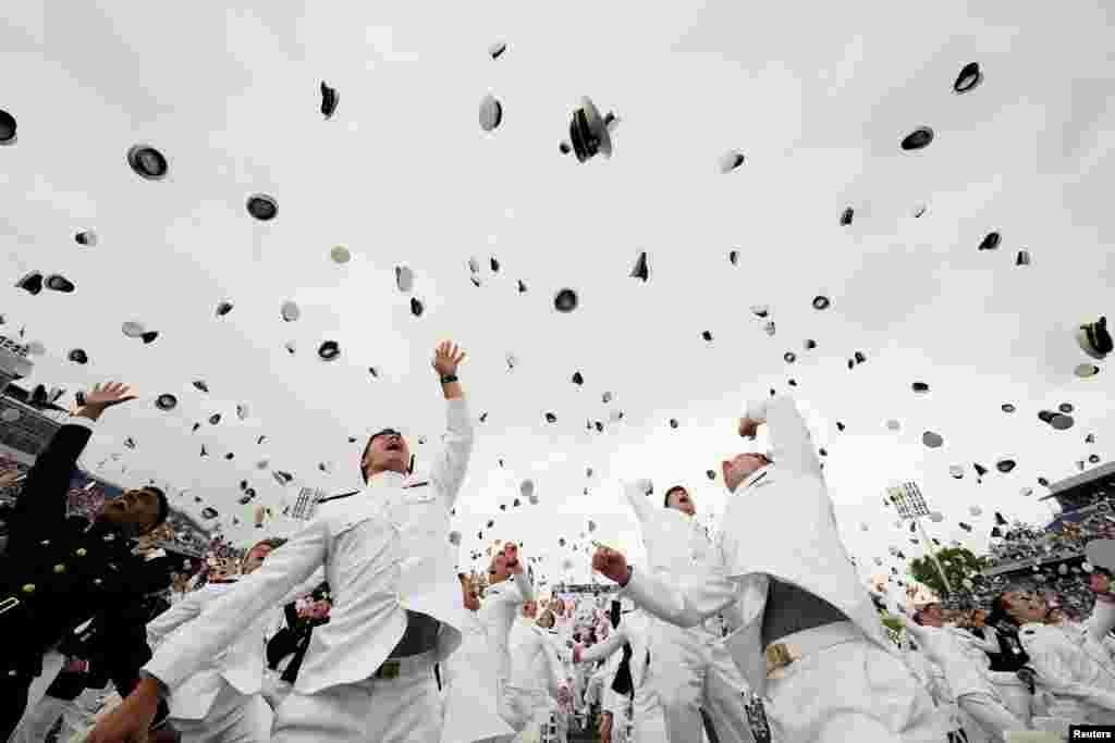 Graduates toss their hats after receiving their diplomas at the graduation and commissioning ceremony for the U.S. Naval Academy&#39;s Class of 2021, at the U.S. Naval Academy in Annapolis, Maryland.