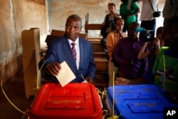 Former Prime Minister Faustin Archange Touadera casts his ballot in the second round of presidential election and the first round of legislative elections in Bangui, Central African Republic, Feb. 14, 2016.