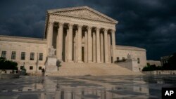 FILE - In this June 20, 2019 file photo, The Supreme Court is seen under stormy skies in Washington. The Supreme Court says it will hear President Donald Trump's pleas to keep his tax, bank and financial records private. 